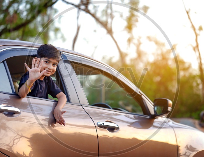Indian Young Boy Or Kid Or Child Playing And  Posing Inside a  Car