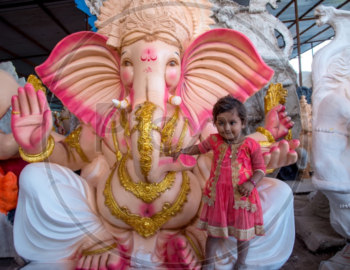 A Small Girl at Lord Ganesh Idols In Workshops For Ganesh Festival  or Ganesh Chathurdhi