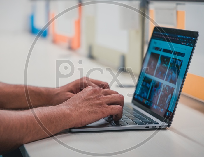 Young Man Or Student Hands On Laptop Keyboard  at Office Desk Background