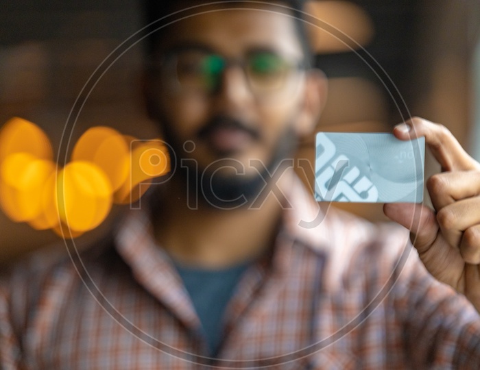 Young Man or Indian Man Holding  Credit Debit Card in Hand Closeup