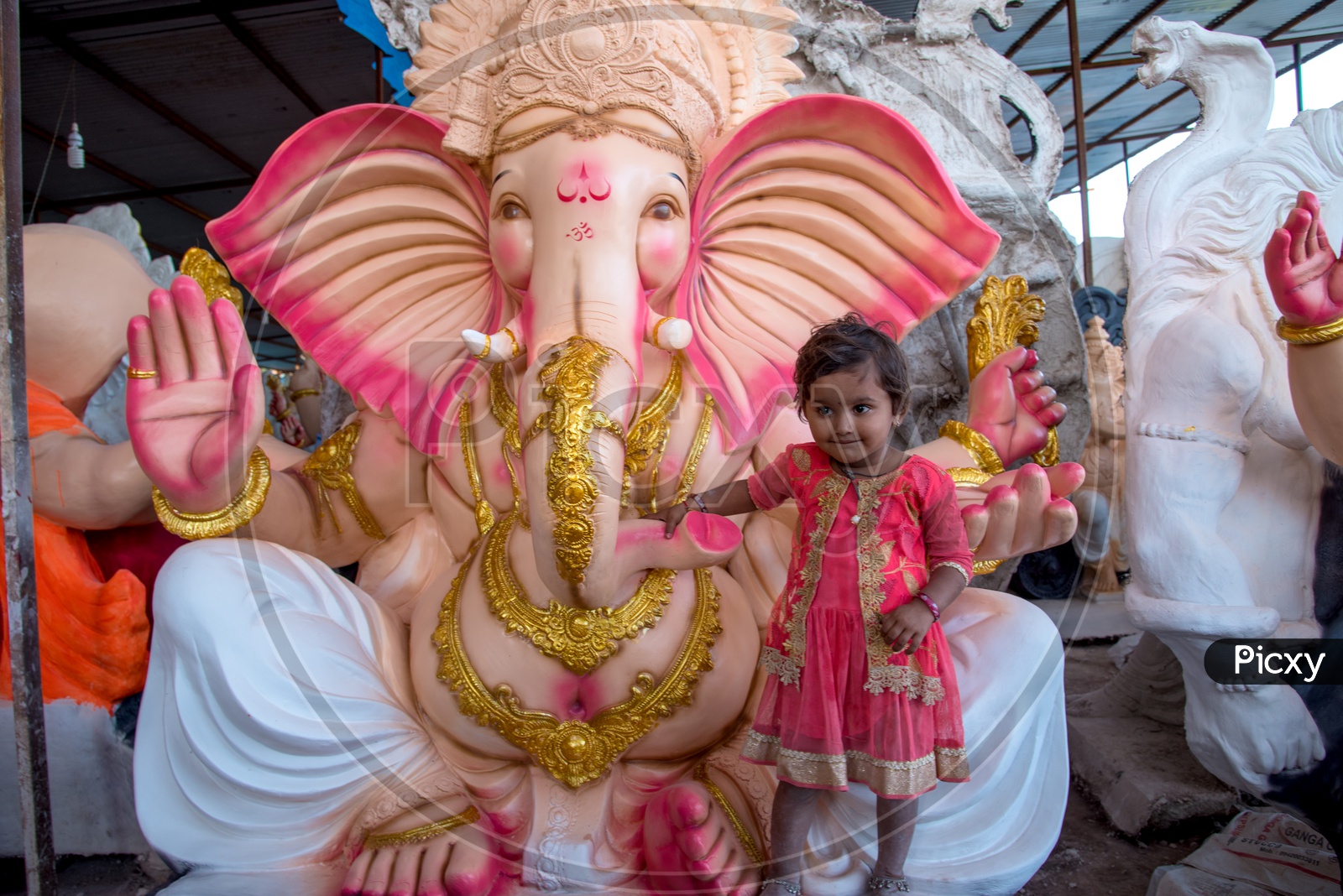 A Small Girl at Lord Ganesh Idols In Workshops For Ganesh Festival  or Ganesh Chathurdhi