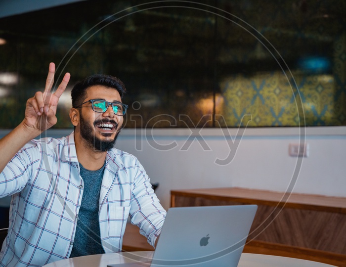 Confident Young Man or Indian Man Or Student With  Happy Gesture and  Happily Smiling With Laptop on Office Desk