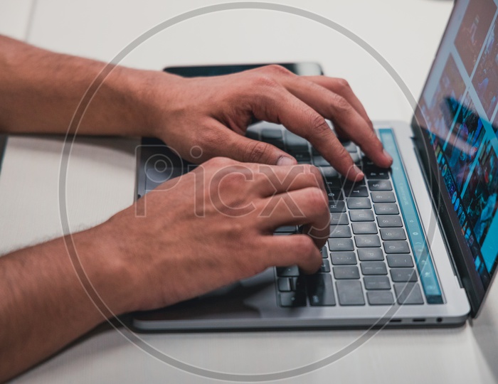Young Man Or Student Hands On Laptop Keyboard  at Office Desk Background