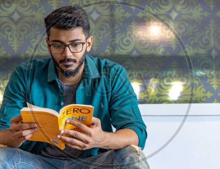 Young Man Or Student Reading Book Or Novel