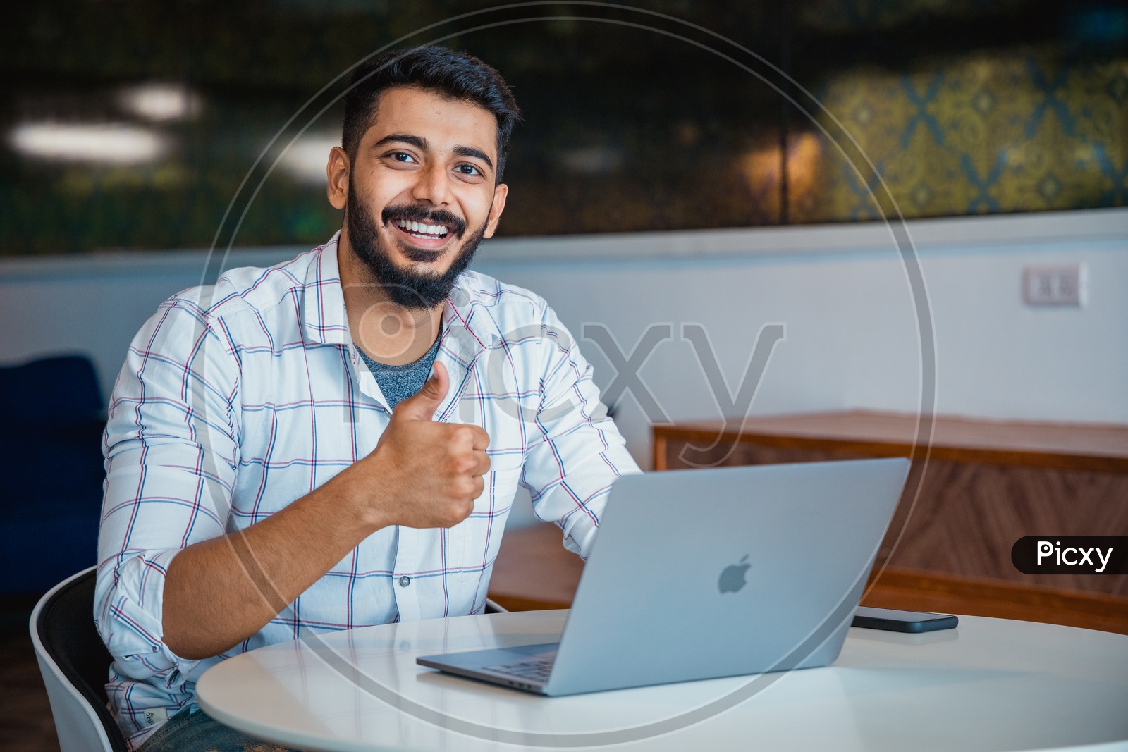 Confident Young Man or Indian Man Or Student With Thump Up Gesture Happily Smiling With Laptop on Office Desk