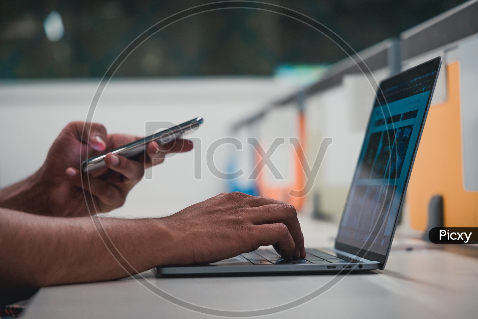 Young Man Or Student Hands Using Mobile Or Smartphone On Laptop Keyboard  On Office  Desk Background