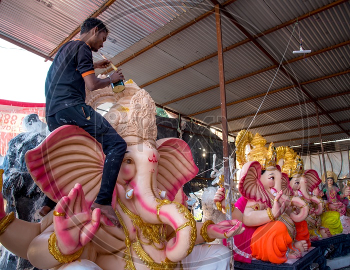 Ganesh Idol Making In Workshops    An Artist Giving  Finishing To Lord Ganesh Idols Made Of Plaster Of Paris  In Workshops