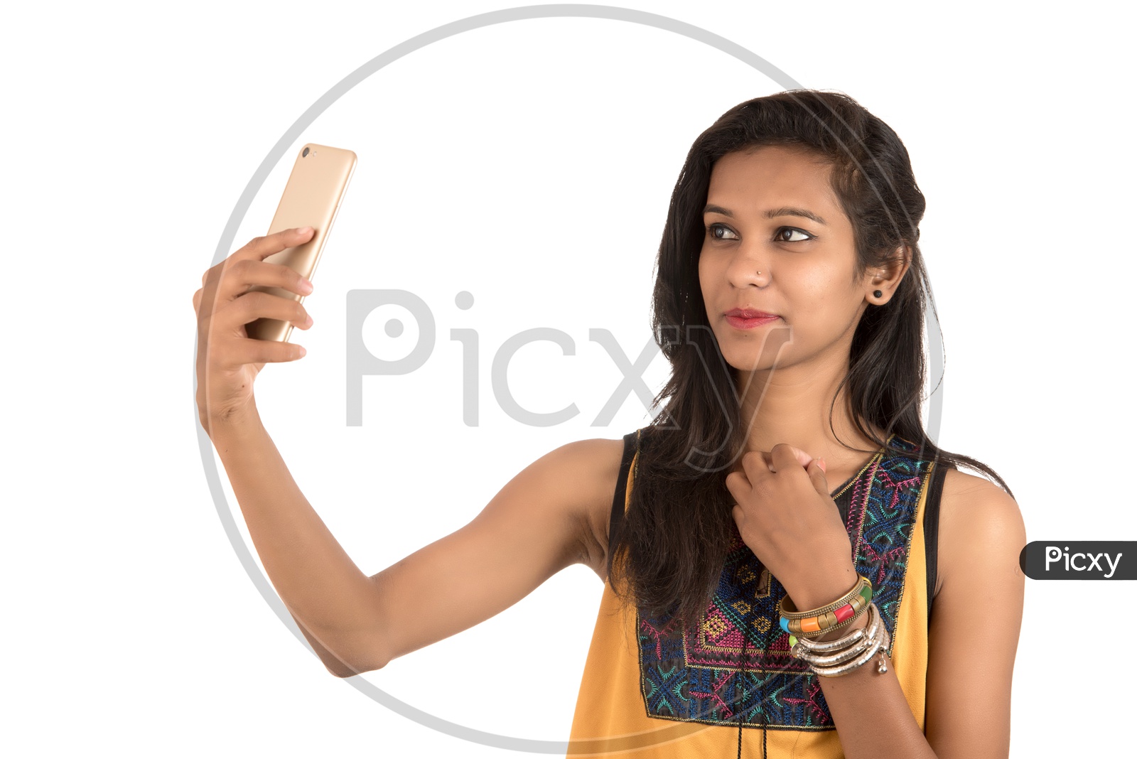 Young Indian Girl Taking Selfie With Mobile Or Smartphone  On an Isolated White Background