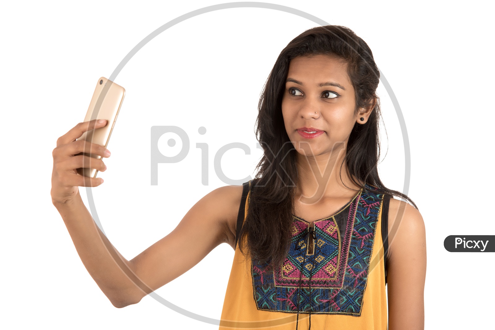 Young Indian Girl Taking Selfie With Mobile Or Smartphone  On an Isolated White Background