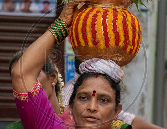 Portrait of woman offering bonalu at Mahankali Temple, secunderabad on the eve of bonalu festival.