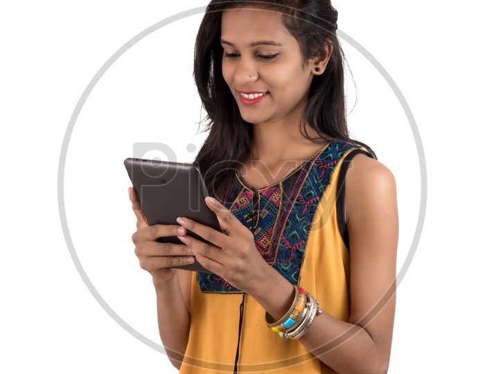 Young  Indian Girl Using  Tab Or Tablet Gadget on an Isolated  White Background