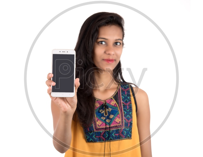 Young Indian Girl  Showing Empty  Mobile Or  Smartphone  Screen  On an Isolated White Background