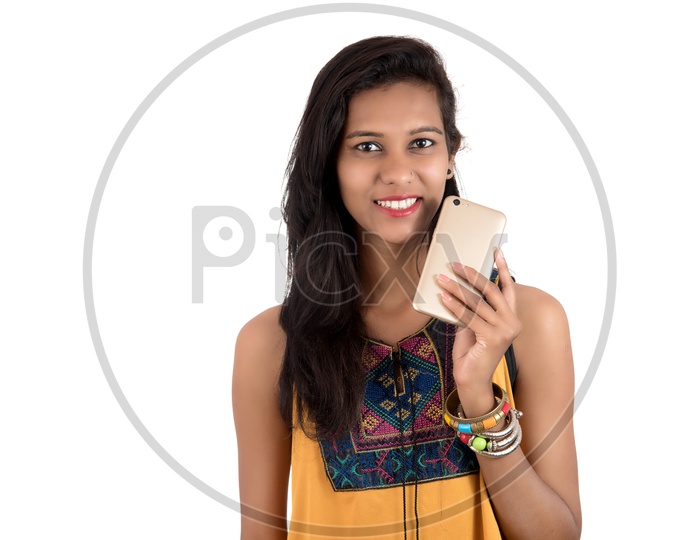 Young  Indian Girl Using   Mobile Or Smartphone on an Isolated  White Background
