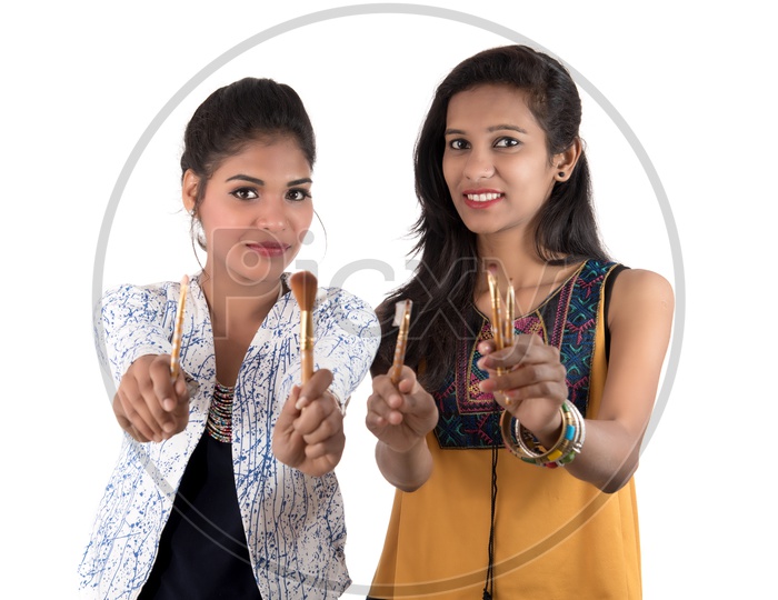 Beautiful Young girls  Holding Makeup brushes in Hand With Smile Face On an isolated White Background