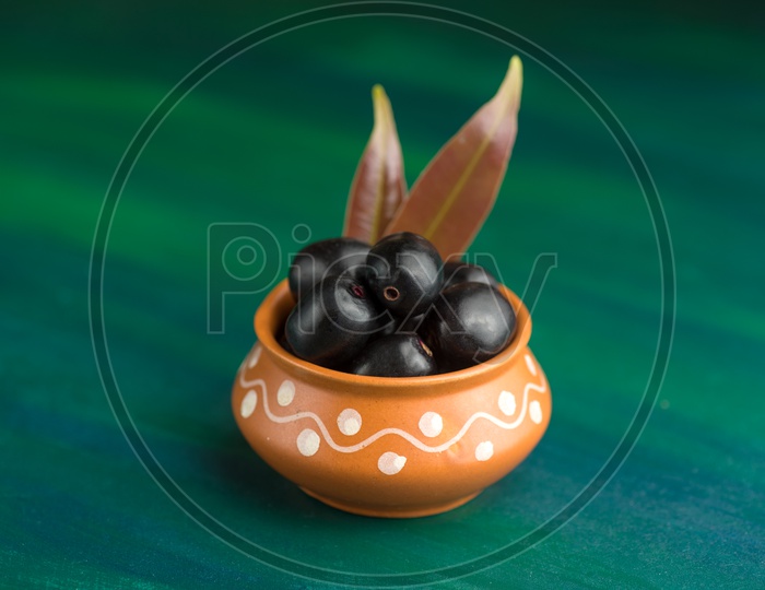 Plum or Jamun Fruit or Jambolan Plum or Jumbul or Java Plum Or Syzygium Cumini or Naeredu on Stone Textured Background