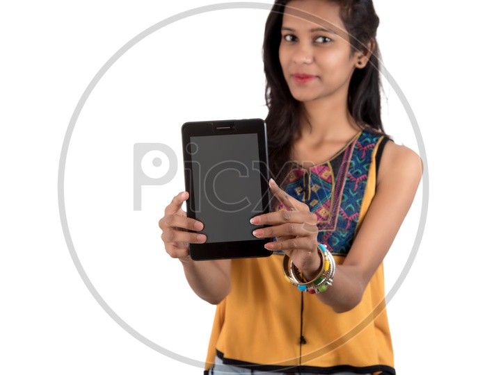 Young Indian Girl Showing Empty Tab Or Tablet Gadget  Screen  On an Isolated White Background