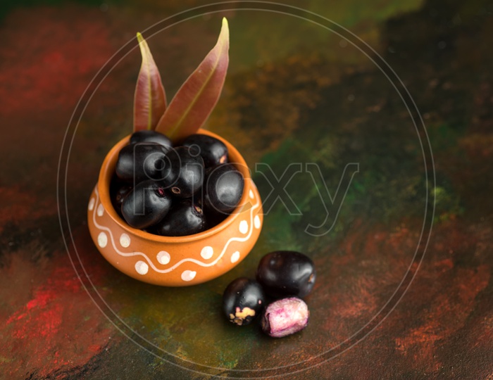 Plum or Jamun Fruit or Jambolan Plum or Jumbul or Java Plum Or Syzygium Cumini or Naeredu on Stone Textured Background
