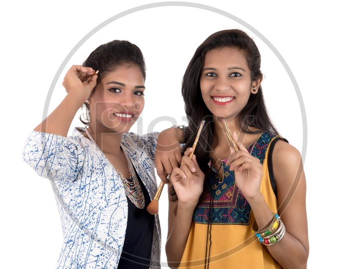 Beautiful Young Indian girls  Holding Makeup brushes in Hand With Smile Face On an isolated White Background