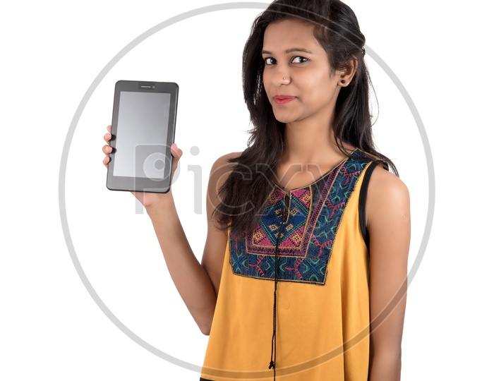 Young Beautiful girl  Showing  Empty Screen of Tab or Tablet Gadget  on an Isolated White  Background
