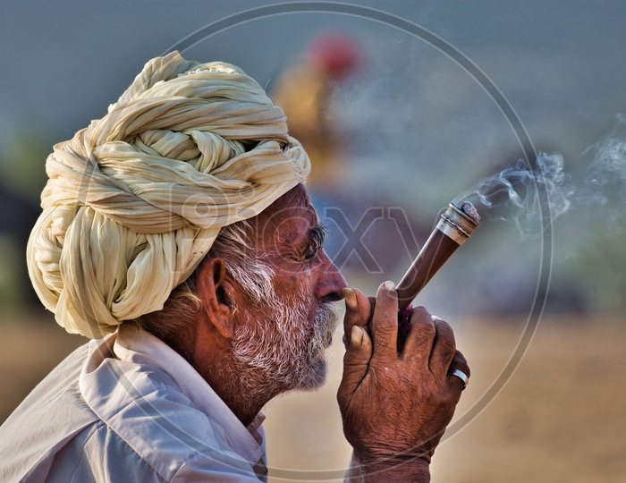 Camel Herder having a smoke early morning