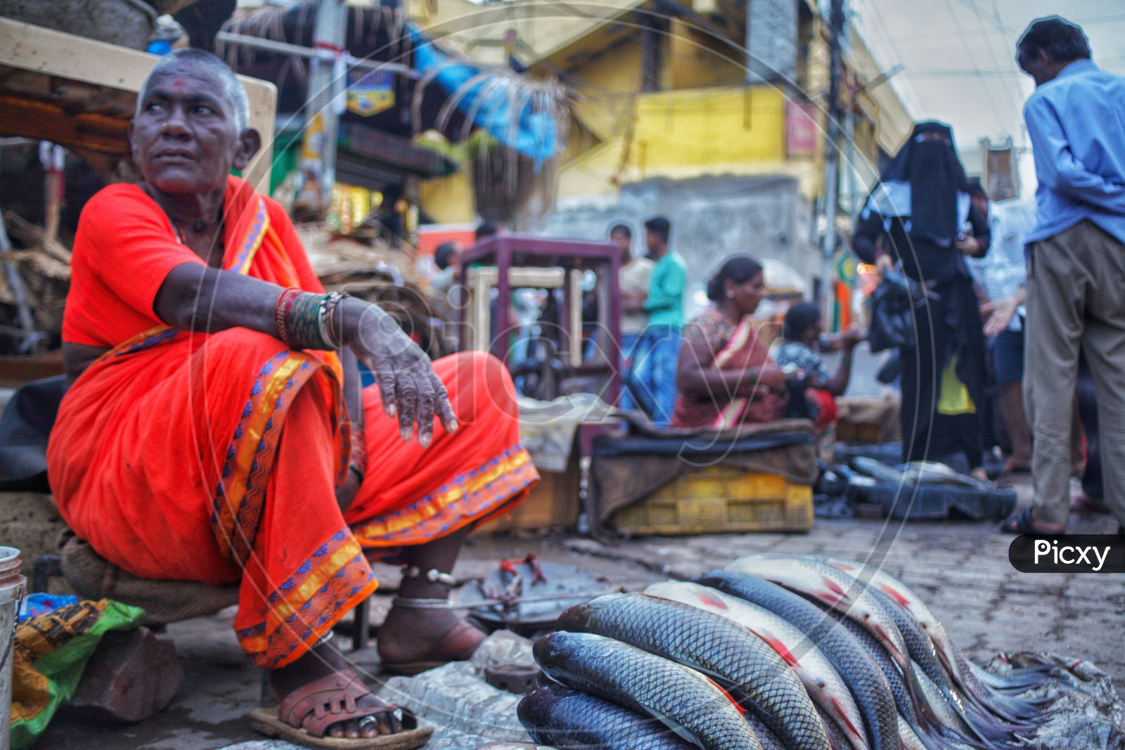 A Woman Vendor Selling Fish In a Market