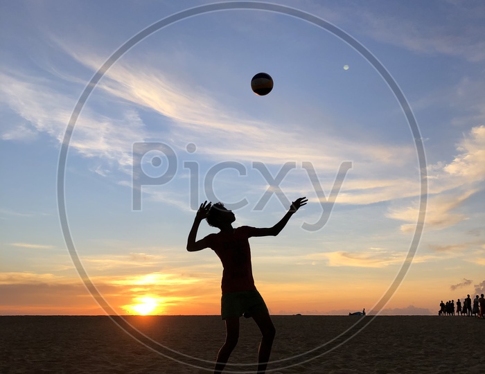 Silhouette Of a Man Playing Beach Volleyball