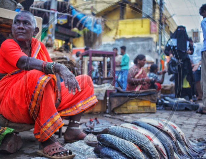 A Woman Vendor Selling Fish In a Market