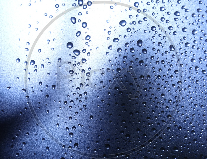 Texture And Patterns Of Water Droplets On a Glass Shield