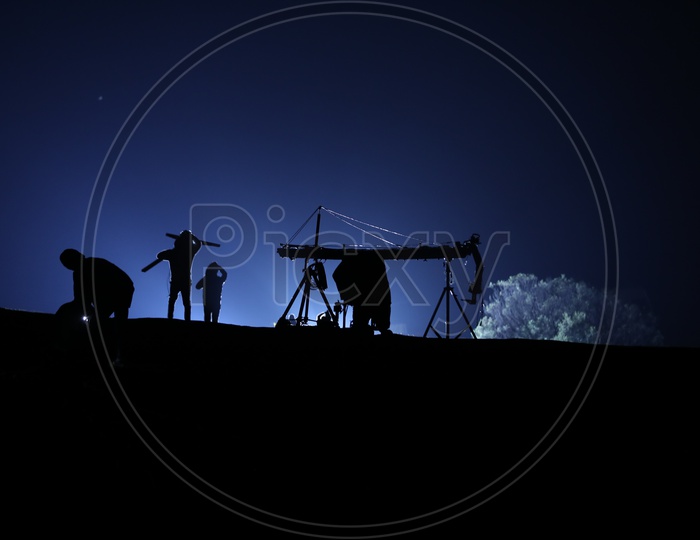 Silhouette Of  Working Man Over a Blue Sky Background