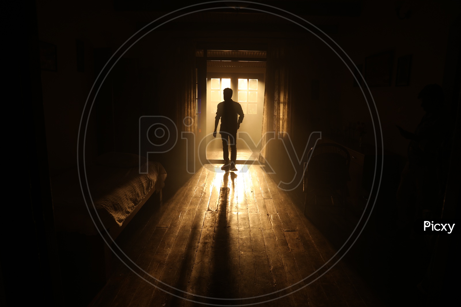 Silhouette Of a Man Standing at  a Door  in a bed room