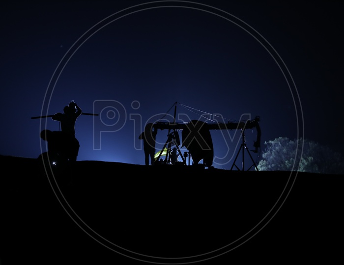 Silhouette Of  Working Man Over a Blue Sky Background