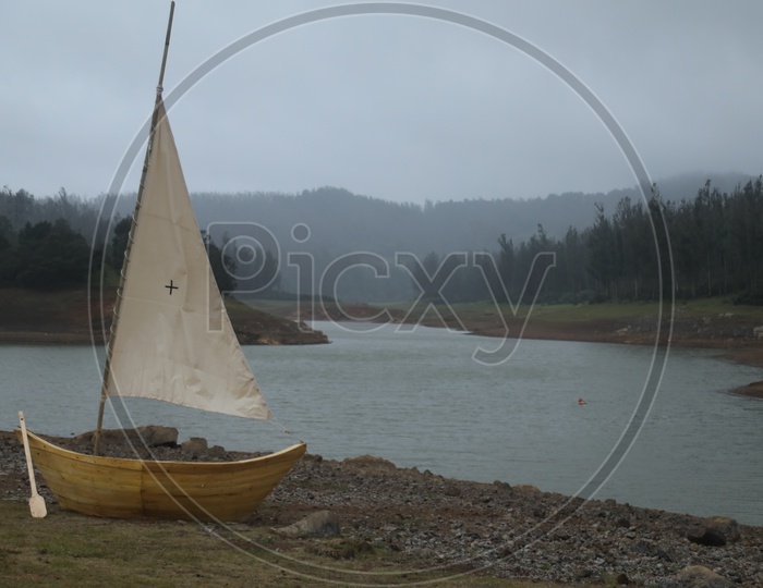 A Lone Boat on The Bank Of a River in a Valley