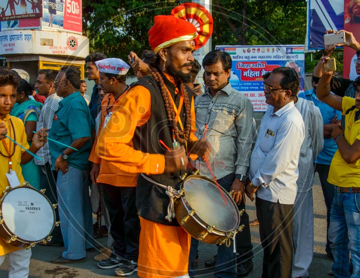 Indian  Folk Drum Players or Band Playing Drums on Streets During Lord Ganesh Procession  for Ganesh Chaturdhi festival
