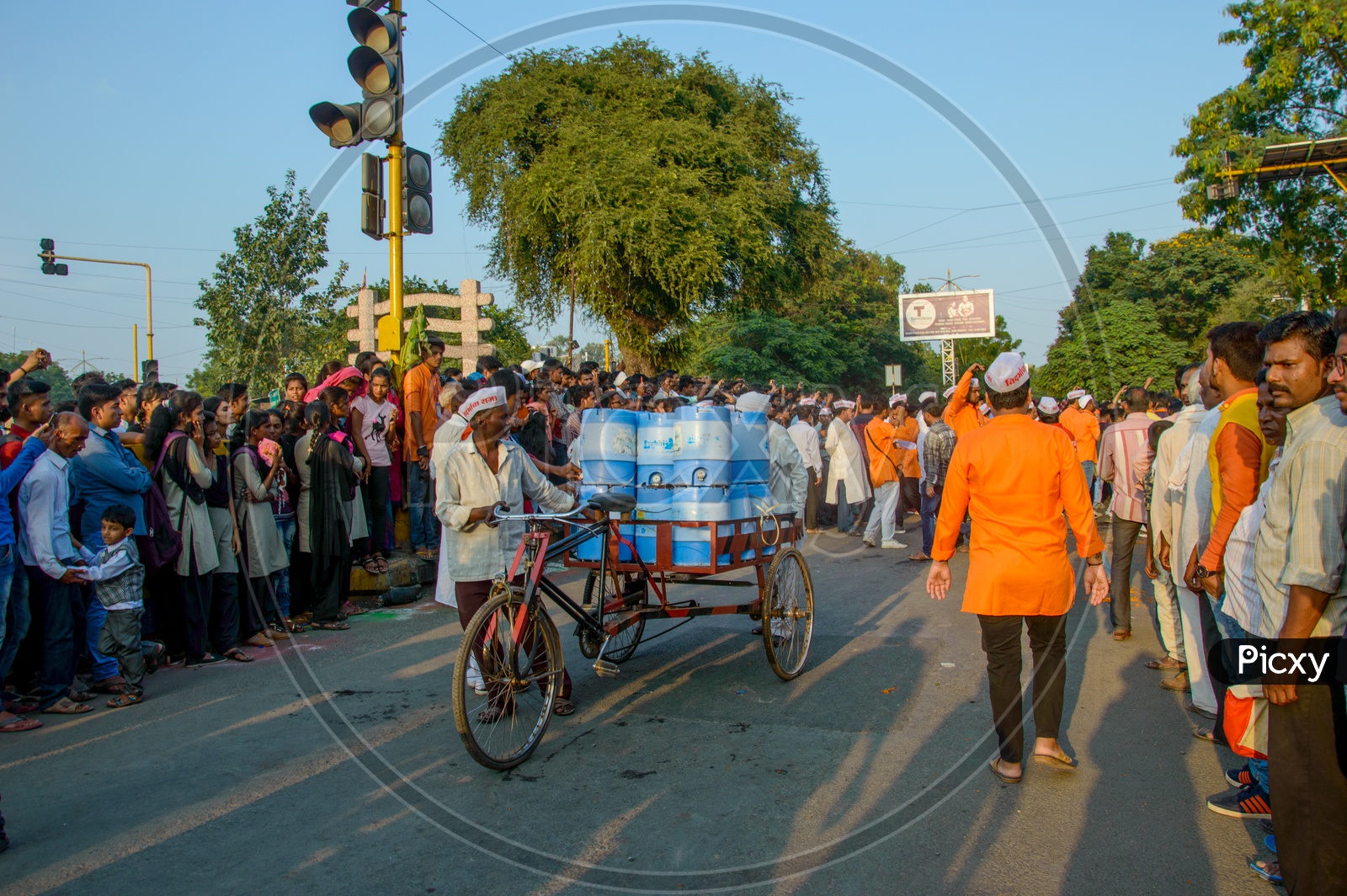 A Rickshaw Puller Carrying Water Bubbles Or Water Cans in Rickshaw