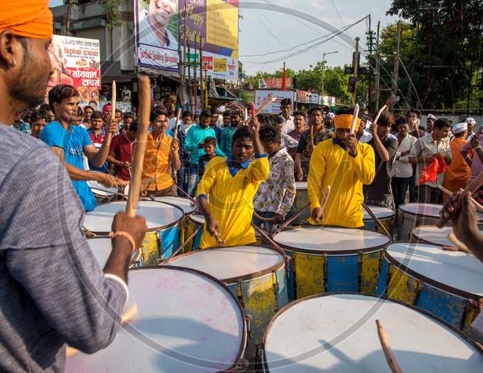 Indian  Folk Drum Players or Band Playing Drums on Streets During Lord Ganesh Procession  for Ganesh Chaturdhi festival