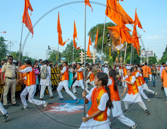 A Group of Man Performing And Dancing On the Streets Holding Saffron Flags During Lord Ganesh  Immersion on Ganesh Chaturdhi Festival
