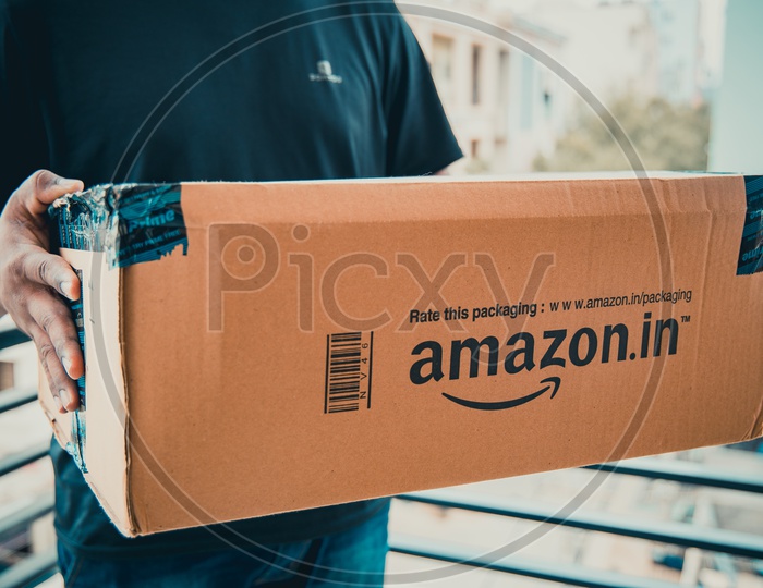 image-of-amazon-delivery-boy-delivering-parcel-rt212148-picxy