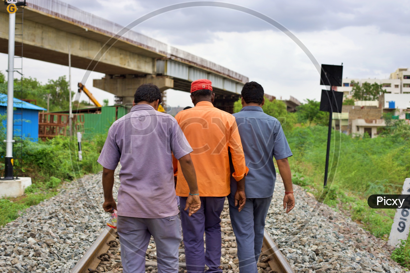 Railway workers walking on tracks.