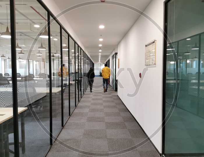 Employees Walking Along The Corridors Of CoWrks Office Working Spaces