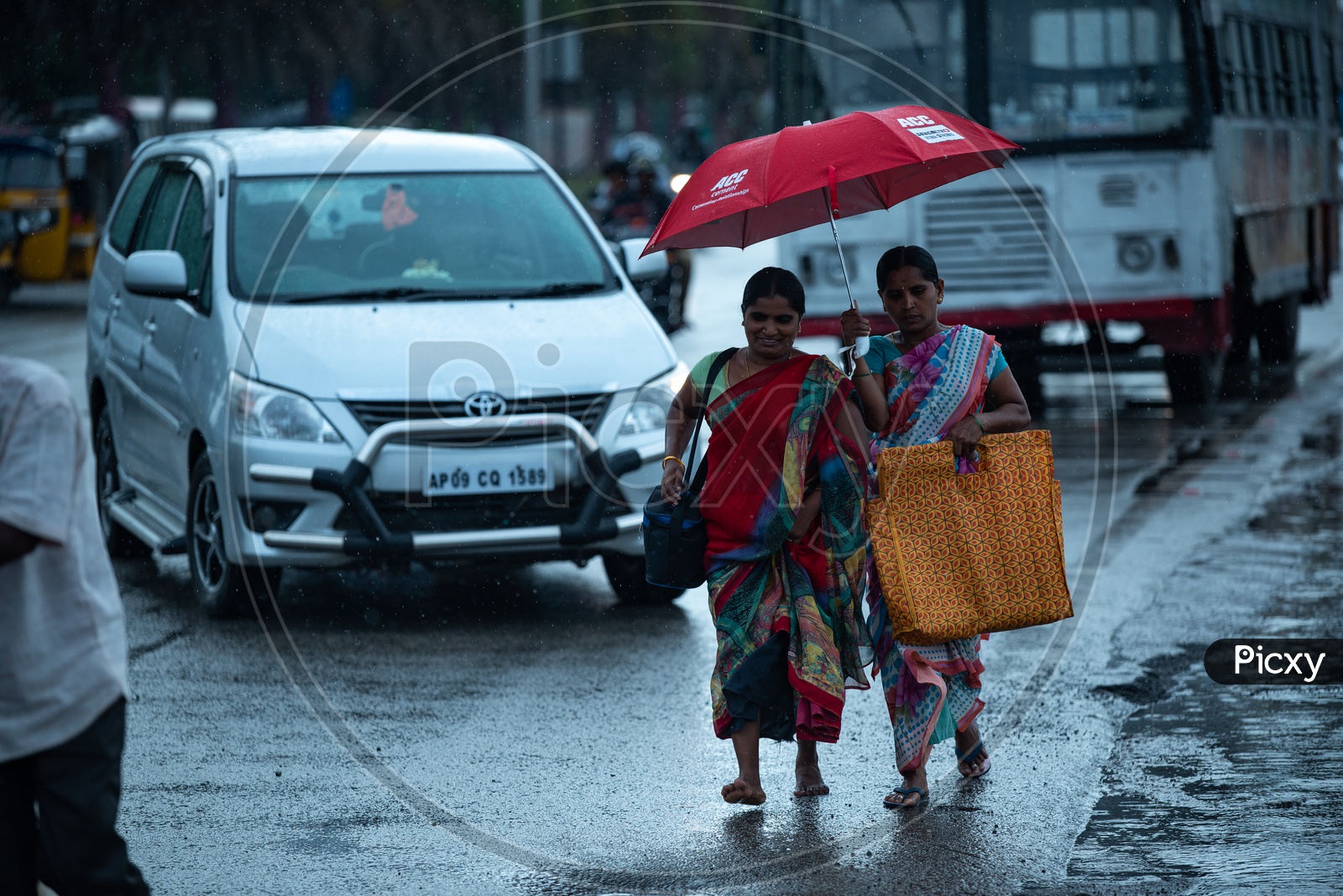 Indian Woman In Rain Under Umbrella On City Roads