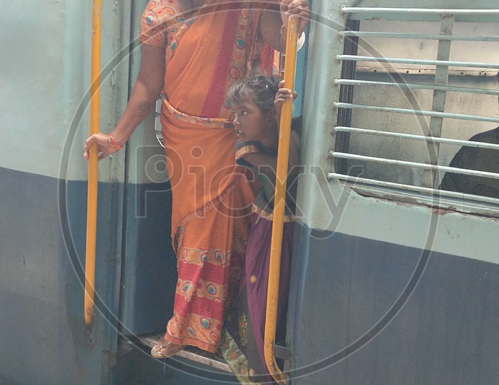 Mother and child waiting for the savouries during the train halt