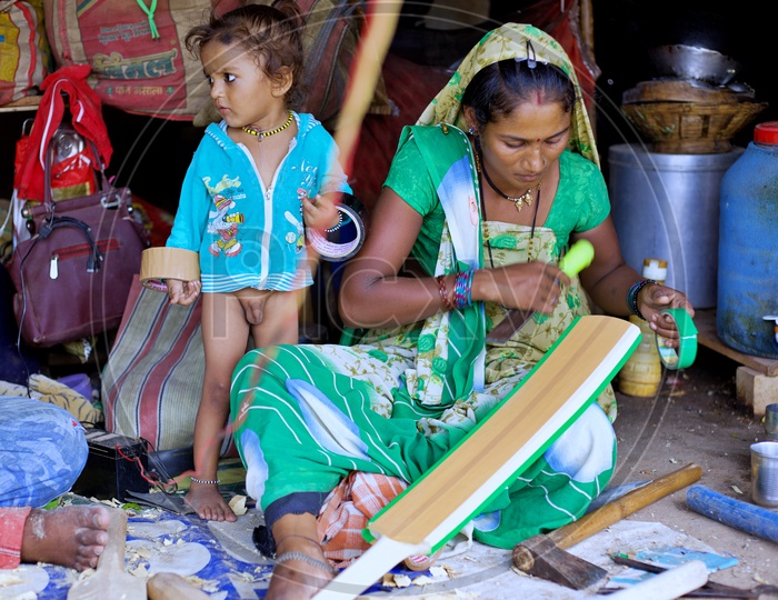 A local women cricket bat maker making cricket bat.