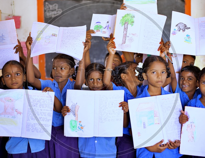 Govt school students showing their books.