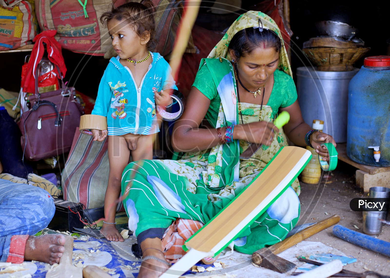 A local women cricket bat maker making cricket bat.