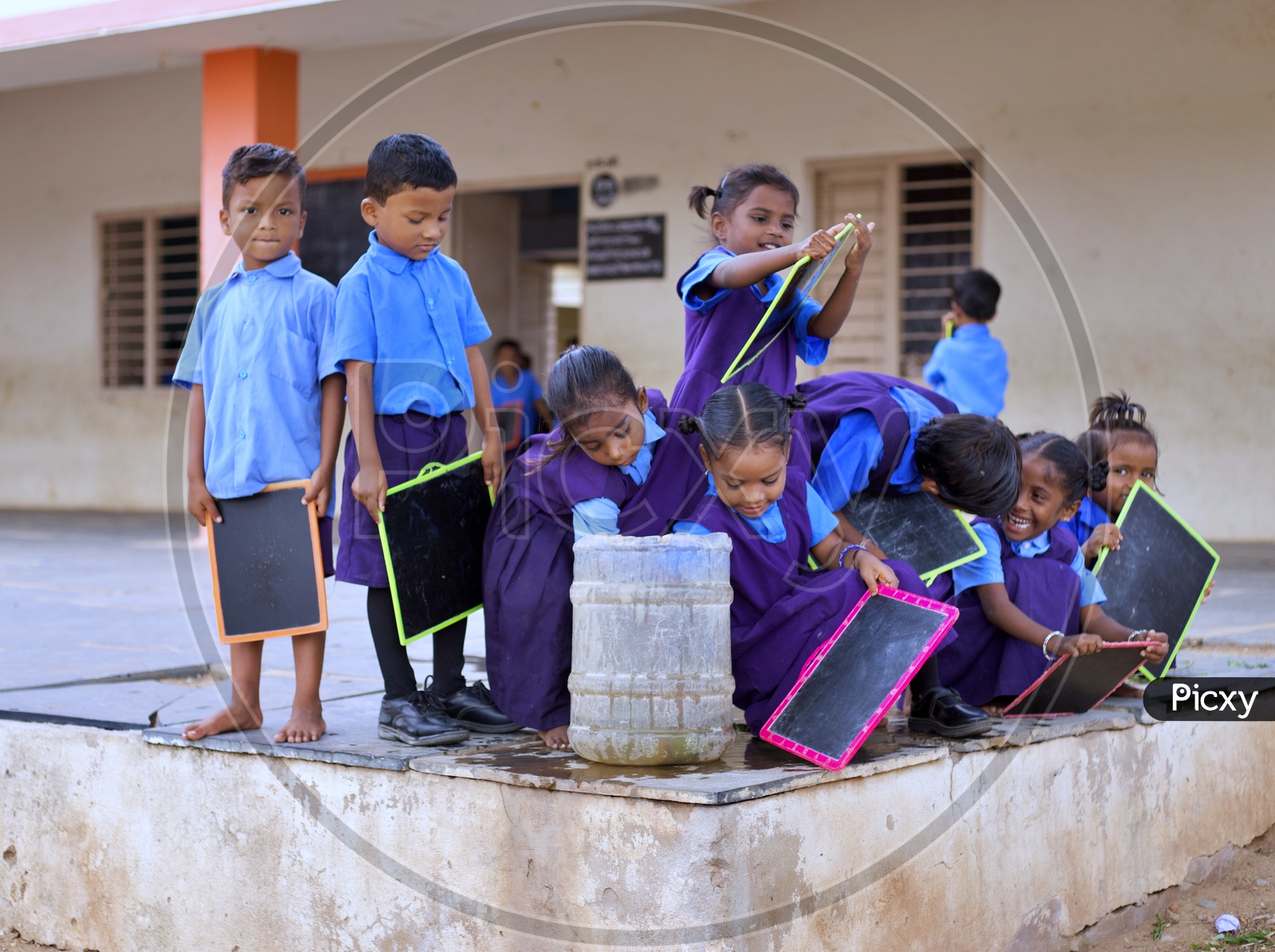 Govt school children washing their slates.