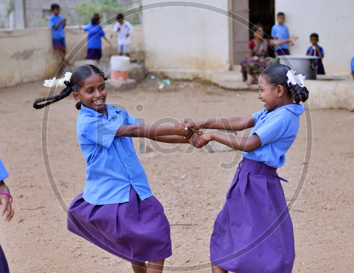 Girl students playing in playground.