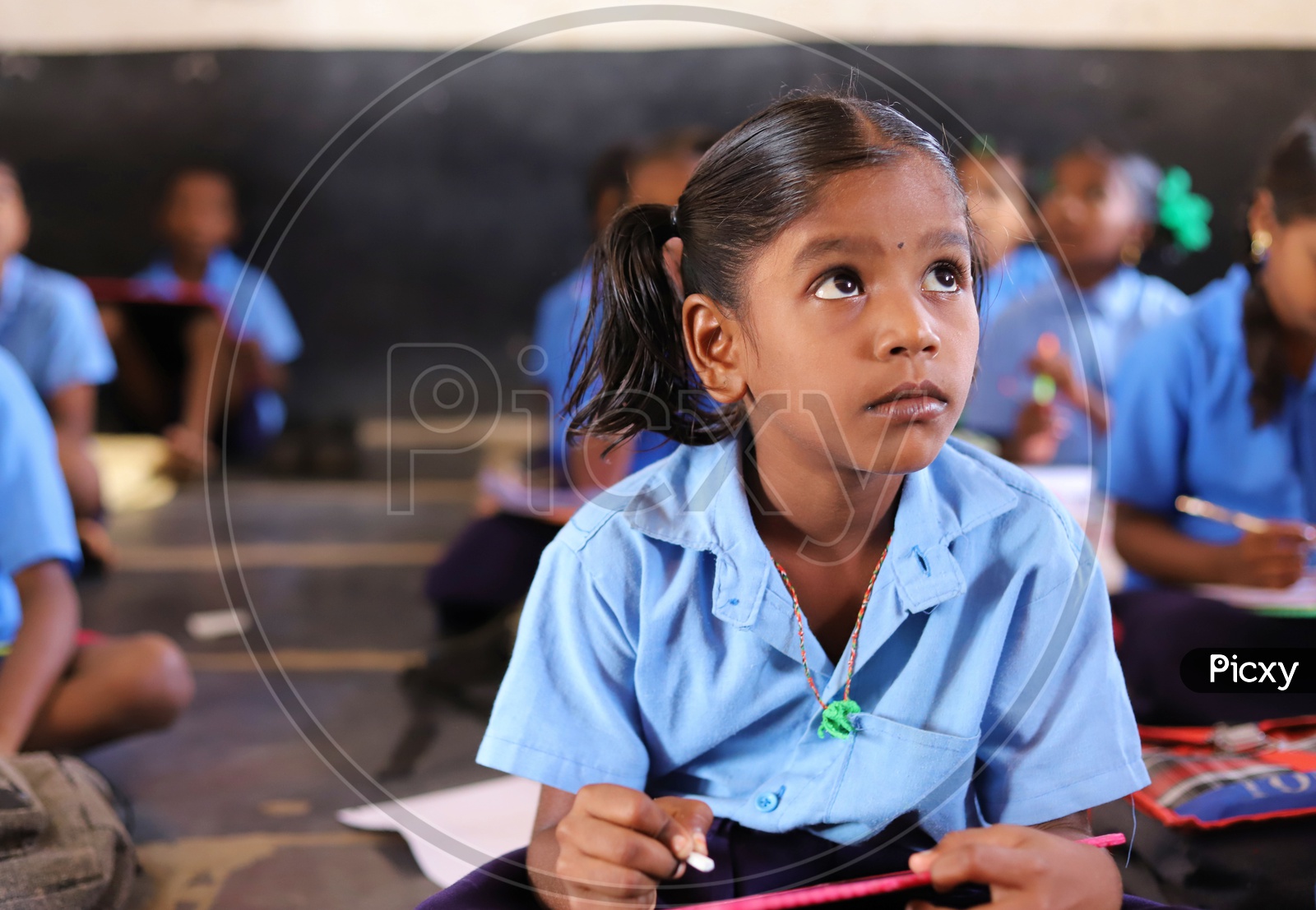 A girl student looking at blackboard.