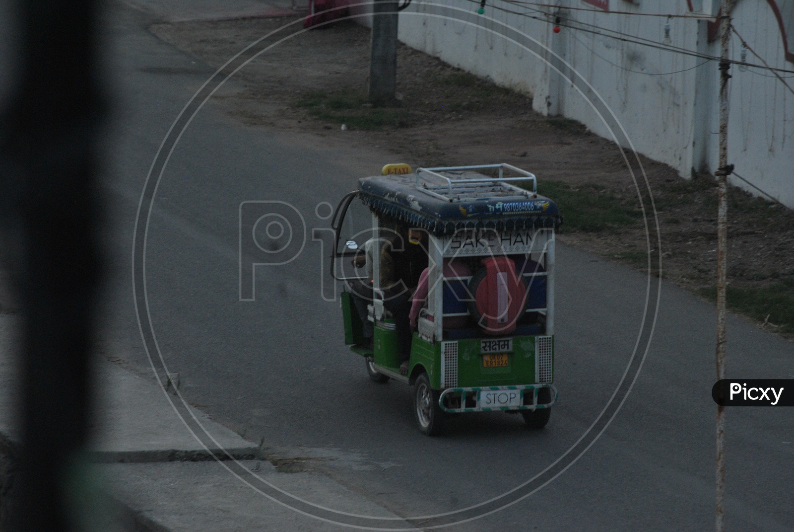 A tuk tuk Rickshaw With People-On-Board