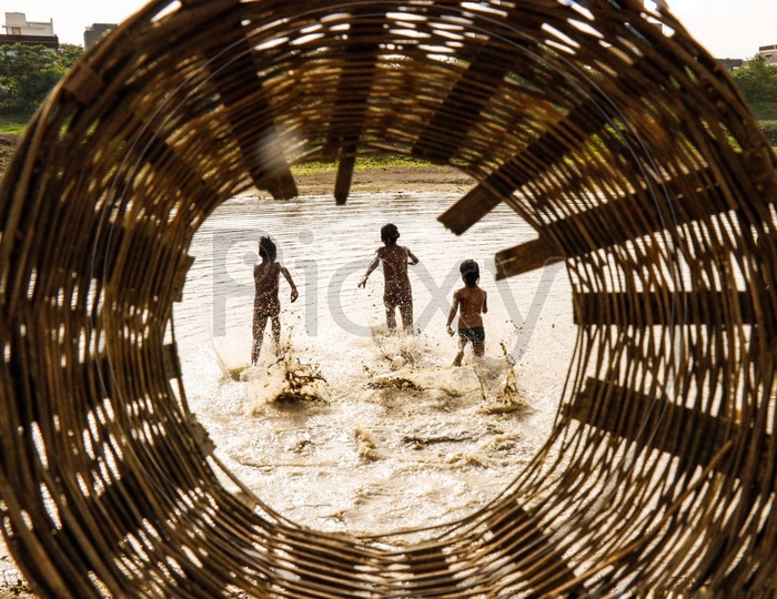 Young  Indian Children Playing In a Water Pond  In Rural Villages