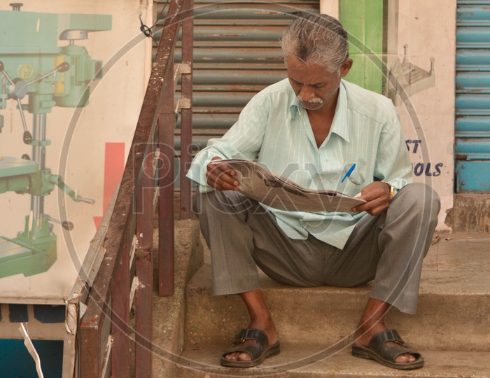 Man reading Newspaper on a sunday